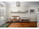 Inviting hallway featuring hardwood floors, stylish decor, and a glimpse of a bench and shelving at 260 Culbreth Rd, Chapel Hill, NC 27516