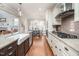 Open kitchen with stainless appliances, center island, hardwood floors, and view into breakfast nook at 260 Culbreth Rd, Chapel Hill, NC 27516