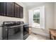 The laundry room offers modern appliances, tiled floors, and a convenient window at 260 Culbreth Rd, Chapel Hill, NC 27516