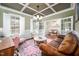 Stylish living room featuring a cozy seating area, coffered ceilings, and a large window at 260 Culbreth Rd, Chapel Hill, NC 27516