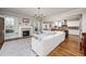 Bright living room with a fireplace, large white sectional sofa, and open view to the kitchen at 260 Culbreth Rd, Chapel Hill, NC 27516