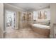 Serene main bathroom with glass shower, soaking tub, tile surround, and natural light at 260 Culbreth Rd, Chapel Hill, NC 27516