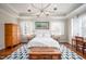 Comfortable main bedroom with hardwood floors, a blue patterned rug, and soft natural light at 260 Culbreth Rd, Chapel Hill, NC 27516