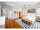 Spacious main bedroom with hardwood floors, a blue patterned rug, and access to ensuite at 260 Culbreth Rd, Chapel Hill, NC 27516