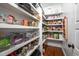 Organized walk-in pantry with shelving, baskets, and clear storage bins for food and kitchen items at 260 Culbreth Rd, Chapel Hill, NC 27516
