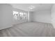 Light-filled bedroom with large windows offering views and plush neutral carpeting at 2826 Huxley Way, Apex, NC 27502