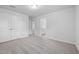 Bright bedroom featuring neutral carpet, white walls, and a view to an ensuite bathroom at 2826 Huxley Way, Apex, NC 27502