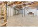 Unfinished basement with exposed ceiling, concrete floor and a partially framed room at 307 Gordon St, Roxboro, NC 27573
