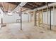 Unfinished basement with exposed ceiling, concrete floor and a partially framed room at 307 Gordon St, Roxboro, NC 27573