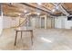 Unfinished basement with exposed ceiling, concrete floor and a partially framed room at 307 Gordon St, Roxboro, NC 27573