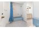 Classic bathroom with blue tile floor, blue tub and shower with white tile walls at 307 Gordon St, Roxboro, NC 27573