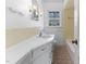 Bathroom featuring a white vanity with drawers and cabinets, and a yellow tile shower at 307 Gordon St, Roxboro, NC 27573