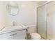 Bright bathroom with a walk in shower, toilet, and a sink with a large mirror at 307 Gordon St, Roxboro, NC 27573