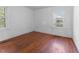 Bright bedroom features hardwood floors, two large windows, and neutral walls at 307 Gordon St, Roxboro, NC 27573