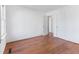 Bedroom features hardwood floors, neutral walls, and two doors at 307 Gordon St, Roxboro, NC 27573