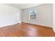 Bedroom with hardwood floors, neutral walls, and a large window with natural light at 307 Gordon St, Roxboro, NC 27573