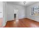 Dining area showcasing hardwood floors, a window, and an archway to the kitchen at 307 Gordon St, Roxboro, NC 27573