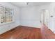 Charming dining room with hardwood floors, a large window, and an arched doorway at 307 Gordon St, Roxboro, NC 27573