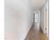 Hallway with wood floors, white walls, and doorways to other rooms of the home at 307 Gordon St, Roxboro, NC 27573