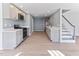 Open concept kitchen features modern gray cabinets, stainless steel appliances, and new luxury vinyl plank flooring at 307 Gordon St, Roxboro, NC 27573