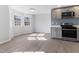 Bright kitchen with stainless steel appliances, gray cabinets, a bay window, and luxury vinyl flooring at 307 Gordon St, Roxboro, NC 27573