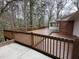 Spacious wooden back deck perfect for entertaining surrounded by mature trees and nature at 318 N Estes Dr, Chapel Hill, NC 27514