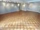 Open basement area with hardwood floors, recessed lights and neutral paint at 318 N Estes Dr, Chapel Hill, NC 27514