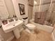 Bathroom featuring vanity sink, toilet, shower and warm lighting at 318 N Estes Dr, Chapel Hill, NC 27514