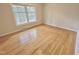 Bedroom with hardwood floors, a large window, and neutral wall color at 318 N Estes Dr, Chapel Hill, NC 27514