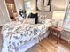 Bright bedroom with stylish bedding, hardwood floors, and a view of the ensuite bathroom at 318 N Estes Dr, Chapel Hill, NC 27514