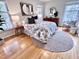 Cozy bedroom with hardwood floors, patterned bedding, and natural light from large windows at 318 N Estes Dr, Chapel Hill, NC 27514