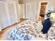Bedroom featuring hardwood floors, closet doors, and an ensuite bathroom entrance at 318 N Estes Dr, Chapel Hill, NC 27514