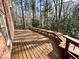 Spacious wooden deck overlooking a serene, wooded backyard, perfect for outdoor relaxation and entertaining at 318 N Estes Dr, Chapel Hill, NC 27514
