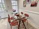 Dining area featuring a glass table, seating for five, and bright light at 318 N Estes Dr, Chapel Hill, NC 27514