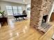 Bright dining room featuring large windows, hardwood floors, and red brick fireplace at 318 N Estes Dr, Chapel Hill, NC 27514