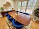 Dining room featuring a large table with blue chairs, hardwood floors, and natural light at 318 N Estes Dr, Chapel Hill, NC 27514