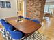 Dining room with hardwood floors, large wood table and blue modern chairs at 318 N Estes Dr, Chapel Hill, NC 27514