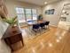 Dining room featuring a table with blue chairs, hardwood flooring, and plenty of natural light at 318 N Estes Dr, Chapel Hill, NC 27514