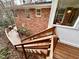 Brick home exterior view showcasing deck, back of home, and landscaping at 318 N Estes Dr, Chapel Hill, NC 27514
