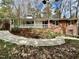 Charming exterior elevation showcasing a welcoming porch, brick accents, and beautiful landscaping at 318 N Estes Dr, Chapel Hill, NC 27514