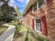 Brick home featuring a concrete path, red shutters, and manicured garden, combining classic charm with modern appeal at 318 N Estes Dr, Chapel Hill, NC 27514