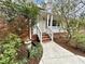 Charming front entrance featuring a brick facade, quaint porch and a well-manicured landscape at 318 N Estes Dr, Chapel Hill, NC 27514