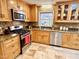 Kitchen featuring stainless steel appliances, granite counters, and beautiful wood cabinets at 318 N Estes Dr, Chapel Hill, NC 27514