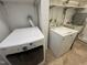 Functional laundry room with washer, dryer, and utility sink at 318 N Estes Dr, Chapel Hill, NC 27514