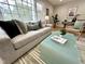 Cozy living room featuring a brick fireplace, hardwood floors, and a comfortable seating arrangement at 318 N Estes Dr, Chapel Hill, NC 27514