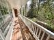 Inviting porch with brick flooring, white railing, and views of the lush surrounding greenery at 318 N Estes Dr, Chapel Hill, NC 27514