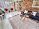 Cozy sunroom featuring lots of natural light, stylish furniture, and brick walls at 318 N Estes Dr, Chapel Hill, NC 27514