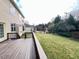 This backyard has a wooden deck, verdant lawn and mature trees, perfect for outdoor enjoyment at 318 S Bend Dr, Durham, NC 27713