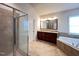 Bathroom featuring a glass shower, soaking tub, and double vanity at 318 S Bend Dr, Durham, NC 27713