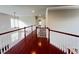 Hallway with hardwood floors, white railings and natural light at 318 S Bend Dr, Durham, NC 27713